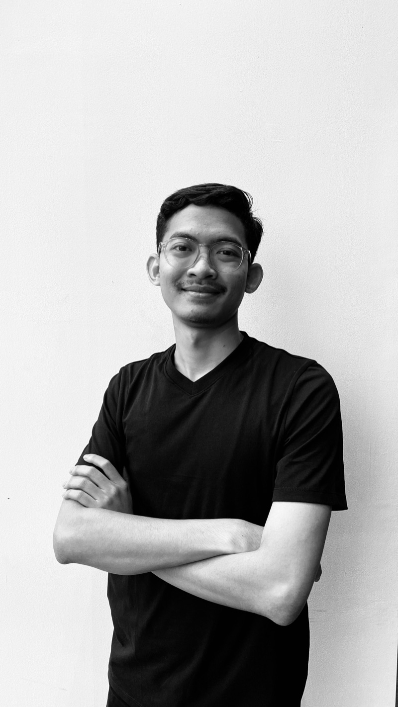 Black and white portrait of Faisal Nur Arif, arms crossed